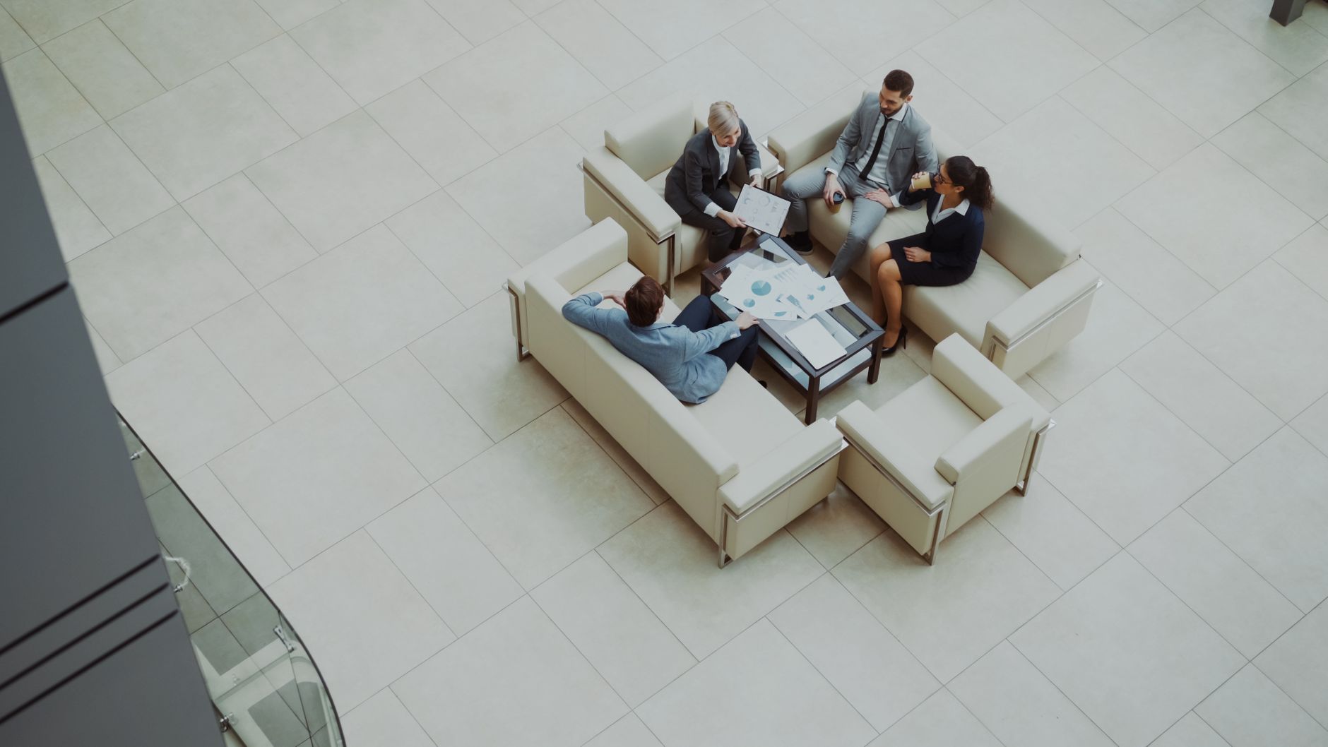 Aerial view of a group business meeting in a modern office setting.