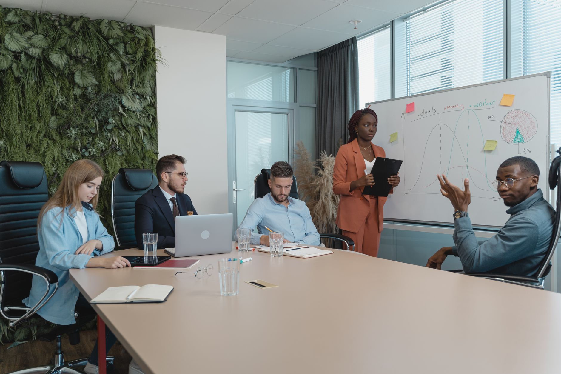 Diverse group of professionals engaged in an innovative brainstorming session in a modern office setting.
