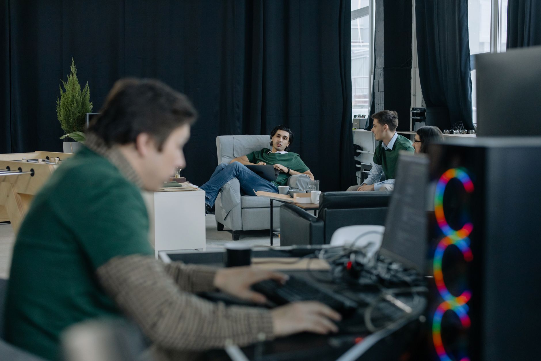 Focused group of professionals in a modern office discussing ideas and working collaboratively.