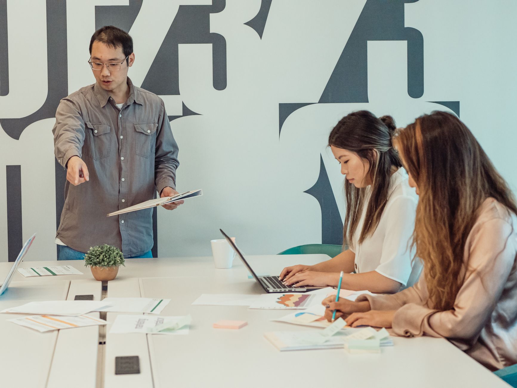 A diverse team in a startup office collaborating and brainstorming ideas for a project.